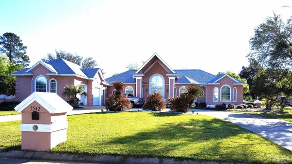 a front view of house with yard and green space