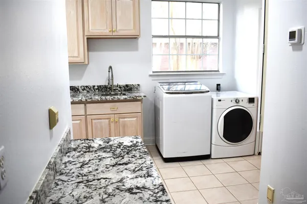 a kitchen with a stove top oven and cabinets