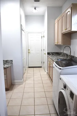 a kitchen with a stove a refrigerator and cabinets