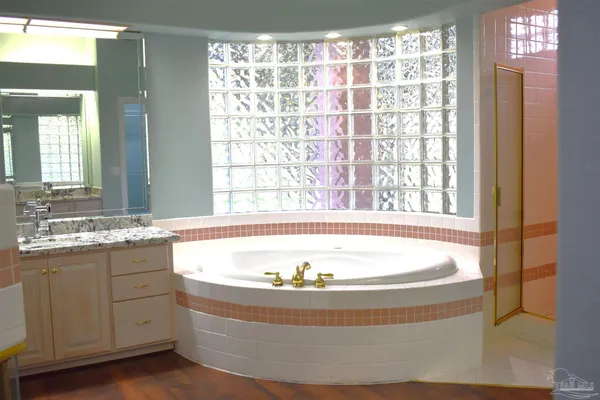 a bathroom with a sink a bathtub and a mirror