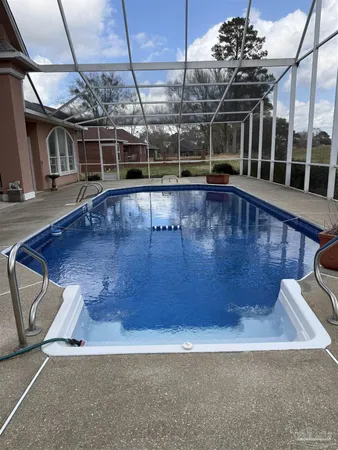 a view of a chairs and table in the patio