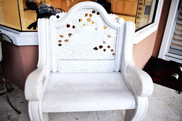 a view of a house with a yard and sitting area