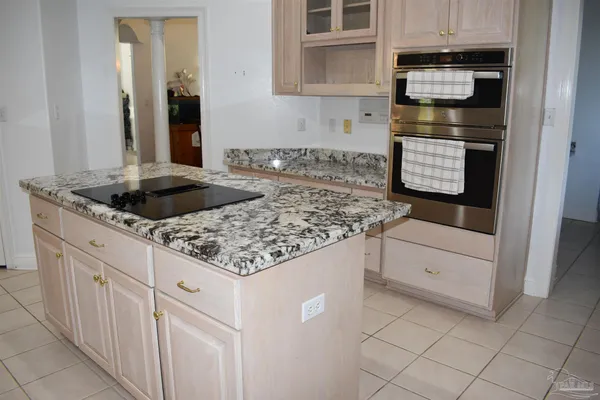 a kitchen with stainless steel appliances granite countertop a sink and a stove