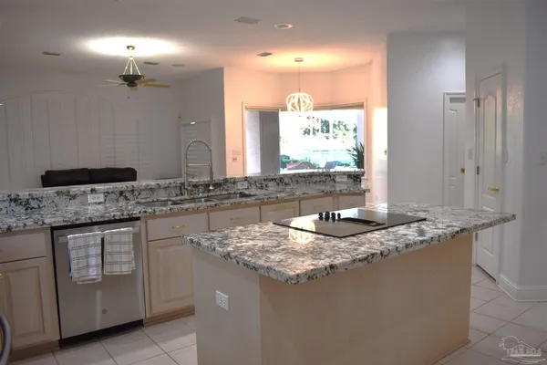 a bathroom with a granite countertop sink a toilet and a mirror
