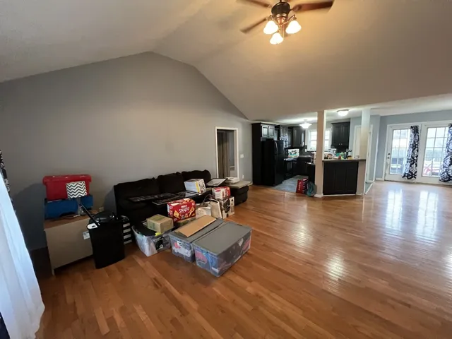 a living room with furniture and wooden floor