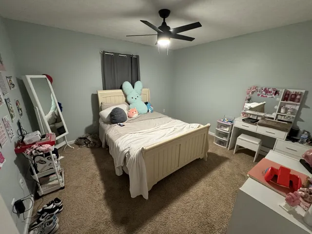 a bedroom with bed and a window