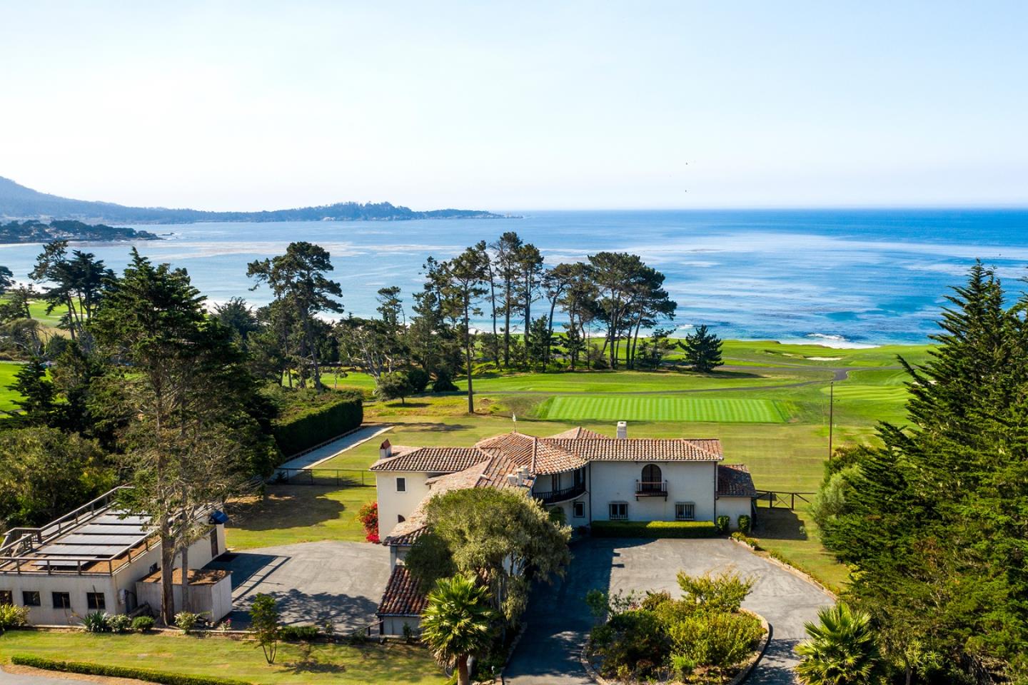 an aerial view of a house with a garden and lake view
