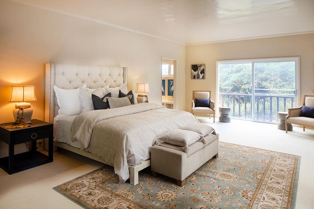 3406 17 Mile Drive Pebble Beach, CA 93953 - Photo 8 of 11 a spacious bedroom with a bed couch and a large window