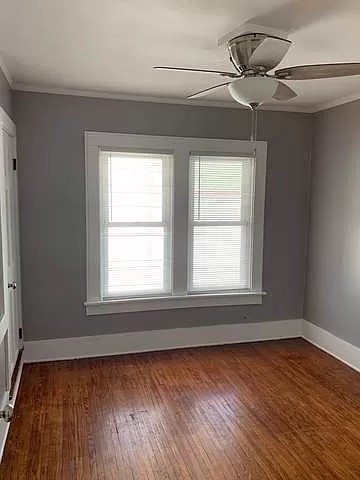 325 North 7th Street DeKalb, IL 60115 - Photo 14 of 20 a view of an empty room with wooden floor and a window