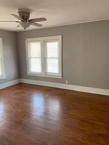 325 North 7th Street DeKalb, IL 60115 - Photo 16 of 20 an empty room with wooden floor fan and windows