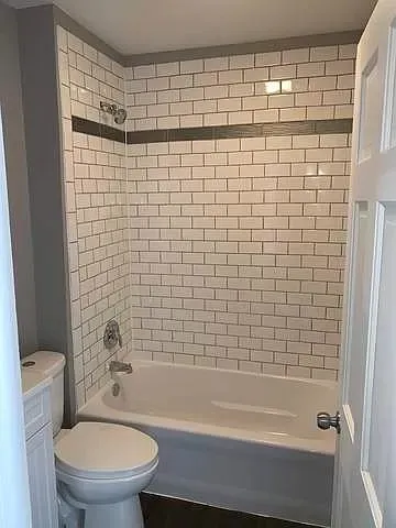 a bathroom with a shower and a toilet
