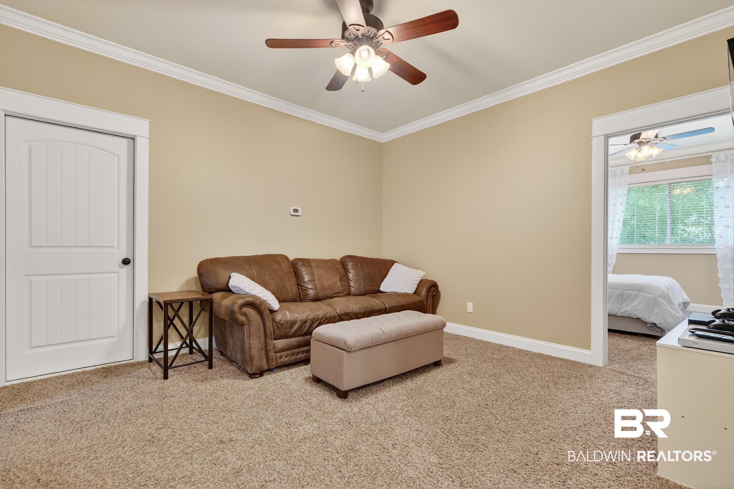 5517 Rabbit Creek Drive Theodore, AL 36582 - Photo 22 of 33 Versatile and open space works well as a cozy hangout, a TV spot, or even a quiet reading nook. It features crown molding and light colored carpet.