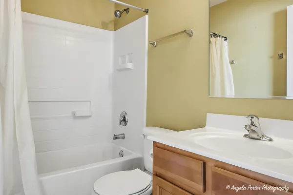 a bedroom with a large bed and a ceiling fan