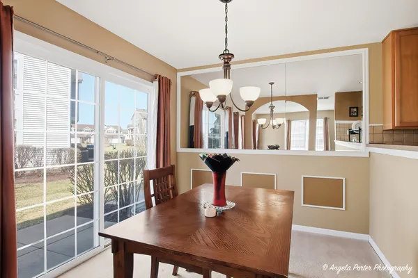 a view of a dining room with furniture wooden floor and chandelier
