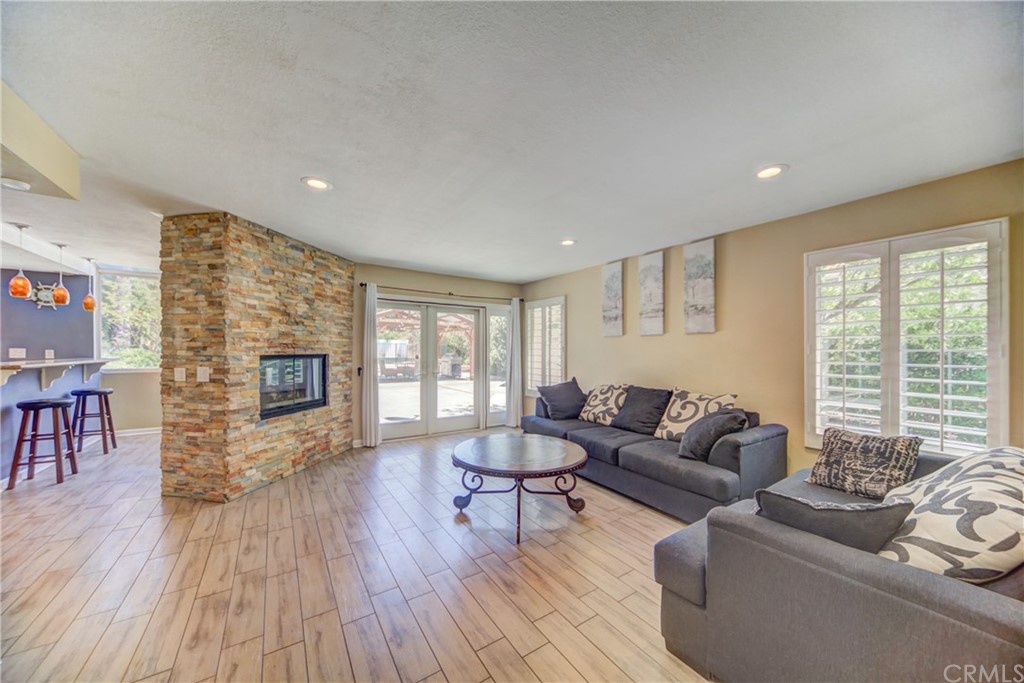 30219 Corte Cantera Temecula, CA 92591 - Photo 12 of 33 a living room with furniture and a fireplace