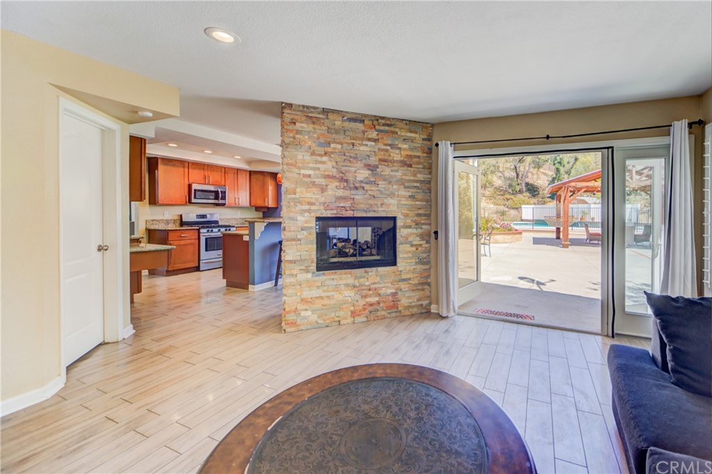30219 Corte Cantera Temecula, CA 92591 - Photo 14 of 33 a living room with furniture and a fireplace