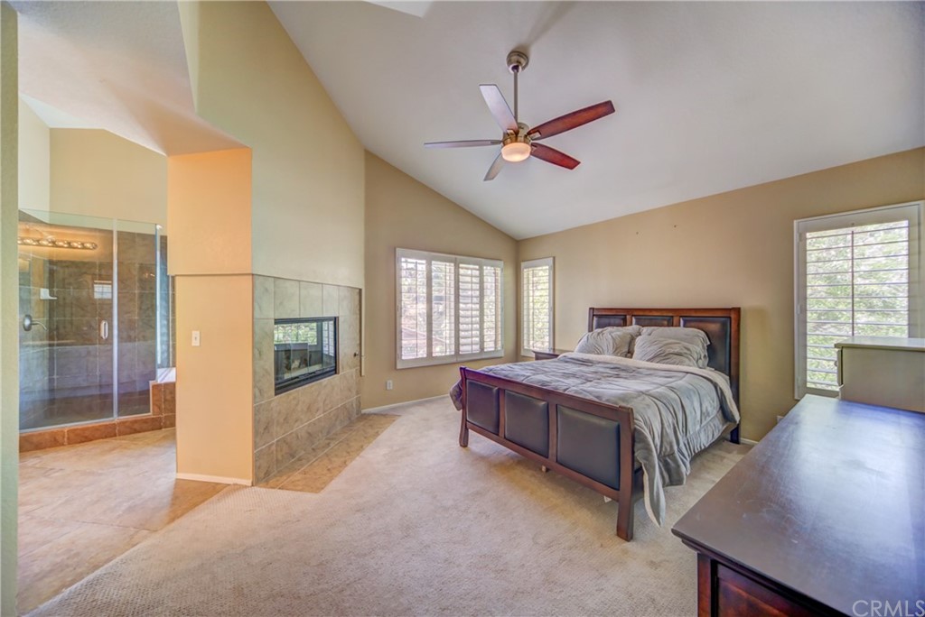 30219 Corte Cantera Temecula, CA 92591 - Photo 15 of 33 a spacious bedroom with a bed a chandelier and a window