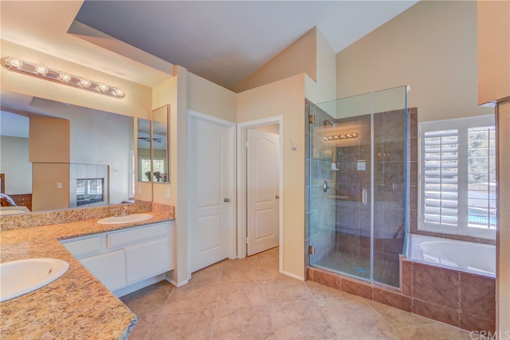 30219 Corte Cantera Temecula, CA 92591 - Photo 17 of 33 a bathroom with a tub shower and sink