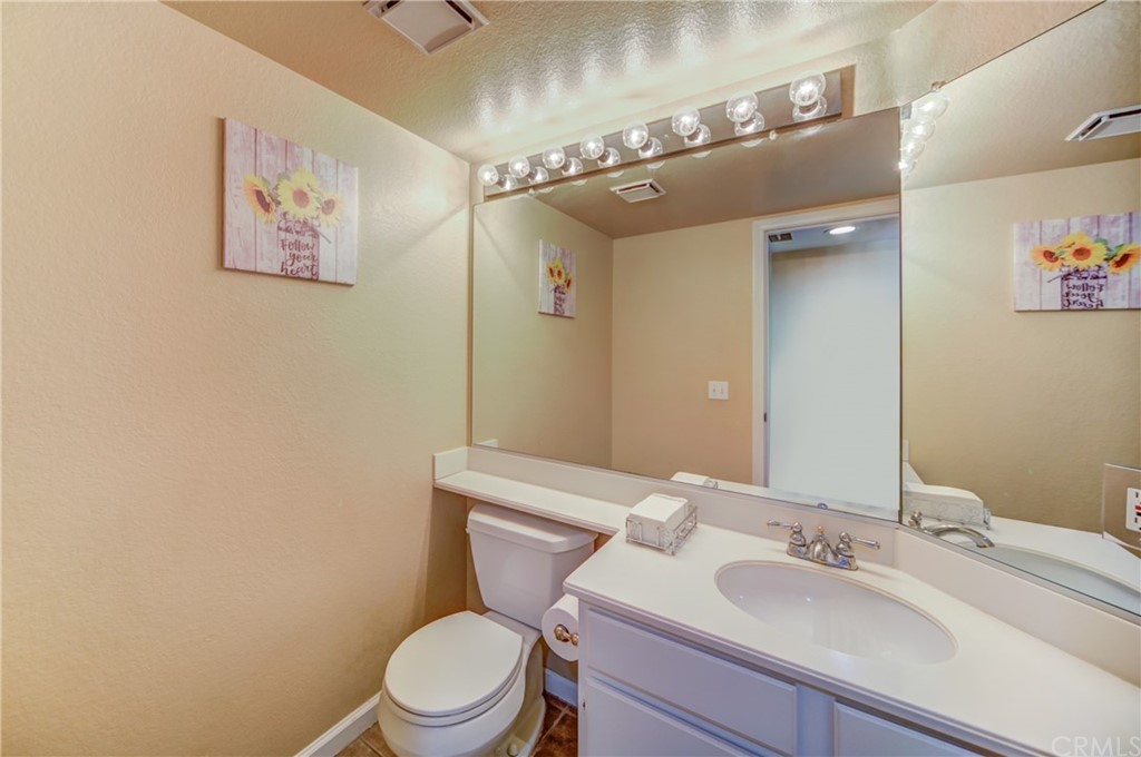 30219 Corte Cantera Temecula, CA 92591 - Photo 21 of 33 a bathroom with a toilet a sink and mirror