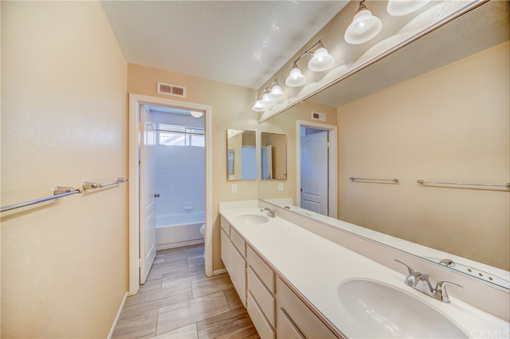30219 Corte Cantera Temecula, CA 92591 - Photo 22 of 33 a bathroom with a double vanity sink and mirror
