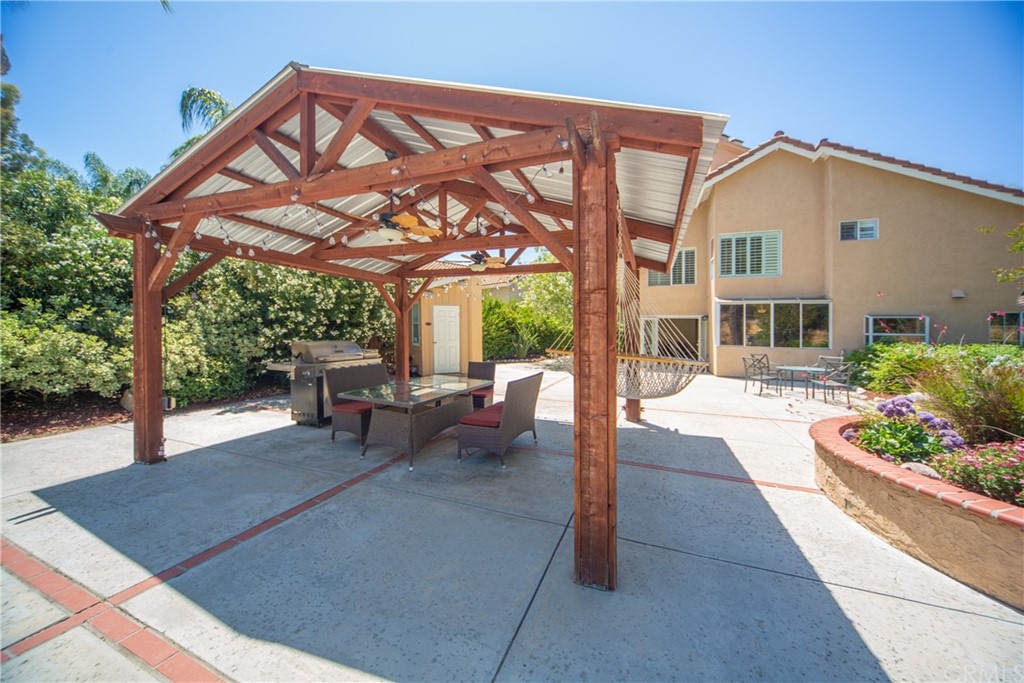 30219 Corte Cantera Temecula, CA 92591 - Photo 29 of 33 a view of a patio with a table and chairs under an umbrella