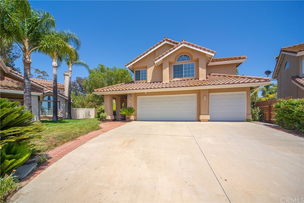 30219 Corte Cantera Temecula, CA 92591 - Photo 3 of 33 a front view of a house with a yard and garage