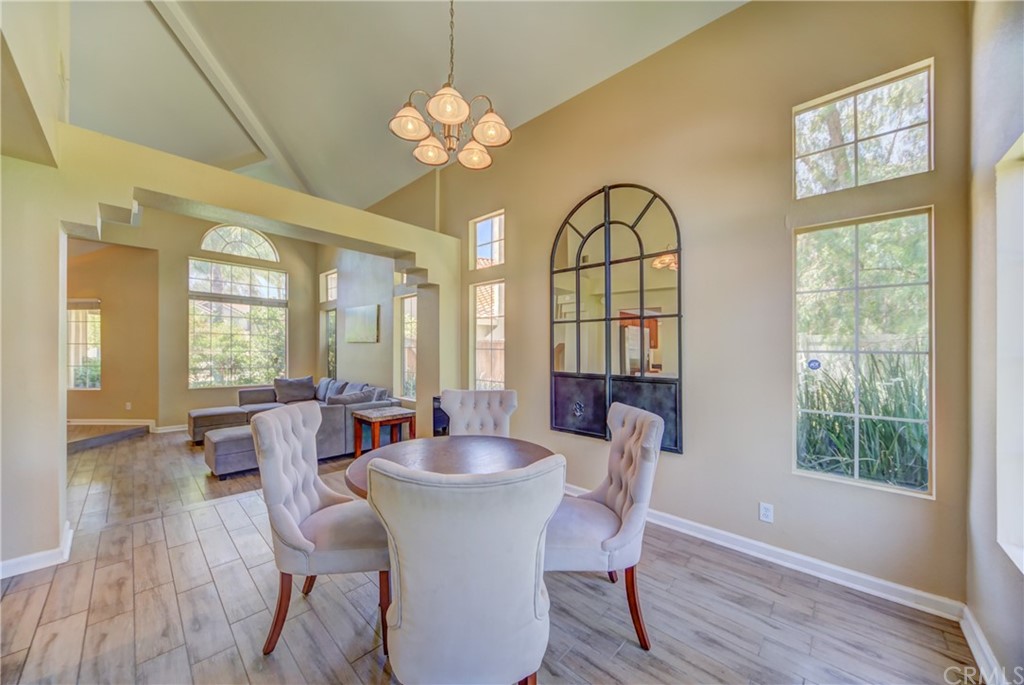 30219 Corte Cantera Temecula, CA 92591 - Photo 7 of 33 a view of a dining room with furniture a chandelier and wooden floor
