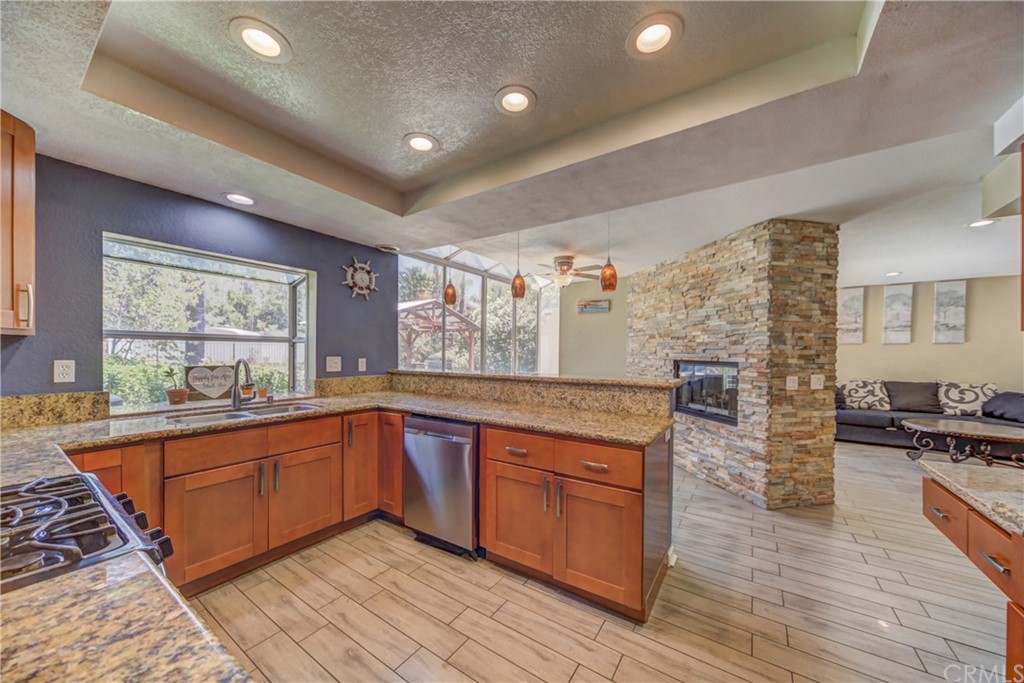 30219 Corte Cantera Temecula, CA 92591 - Photo 9 of 33 a large kitchen with stainless steel appliances granite countertop a stove and a sink