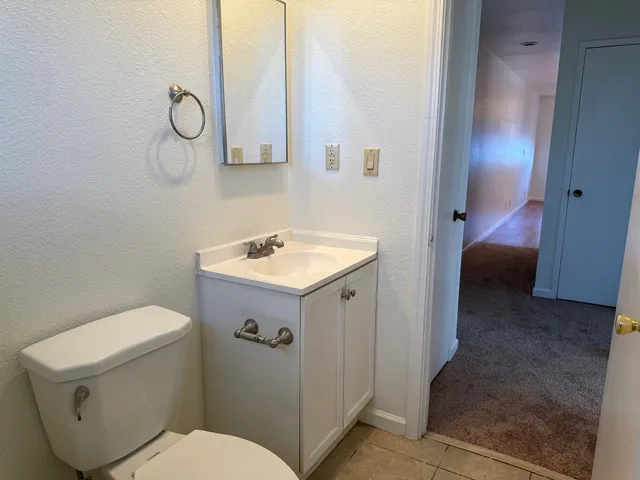 a bathroom with a sink toilet and vanity