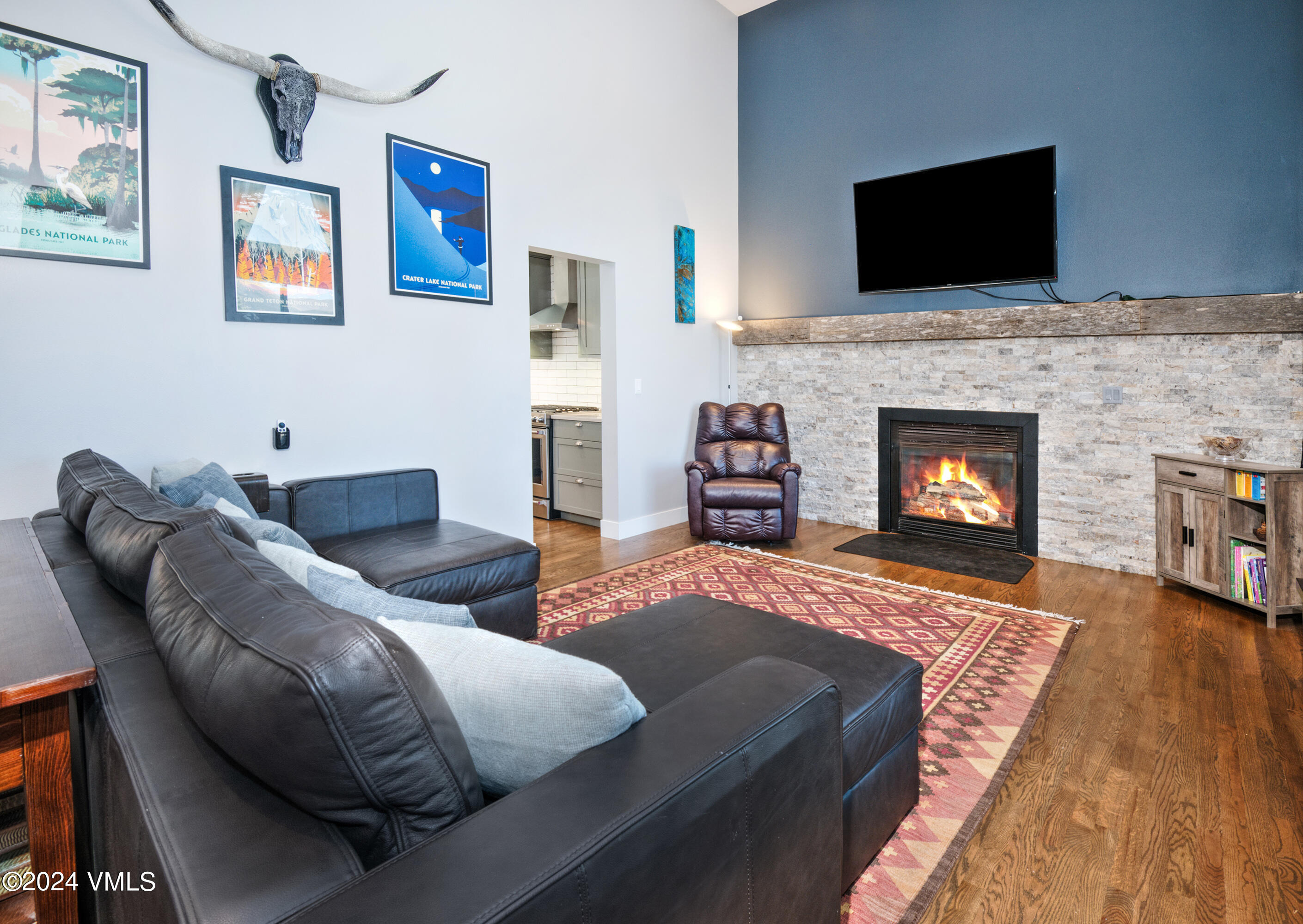 206 Golden Eagle Eagle, CO 81631 - Photo 15 of 47 a living room with furniture a flat screen tv and a fireplace