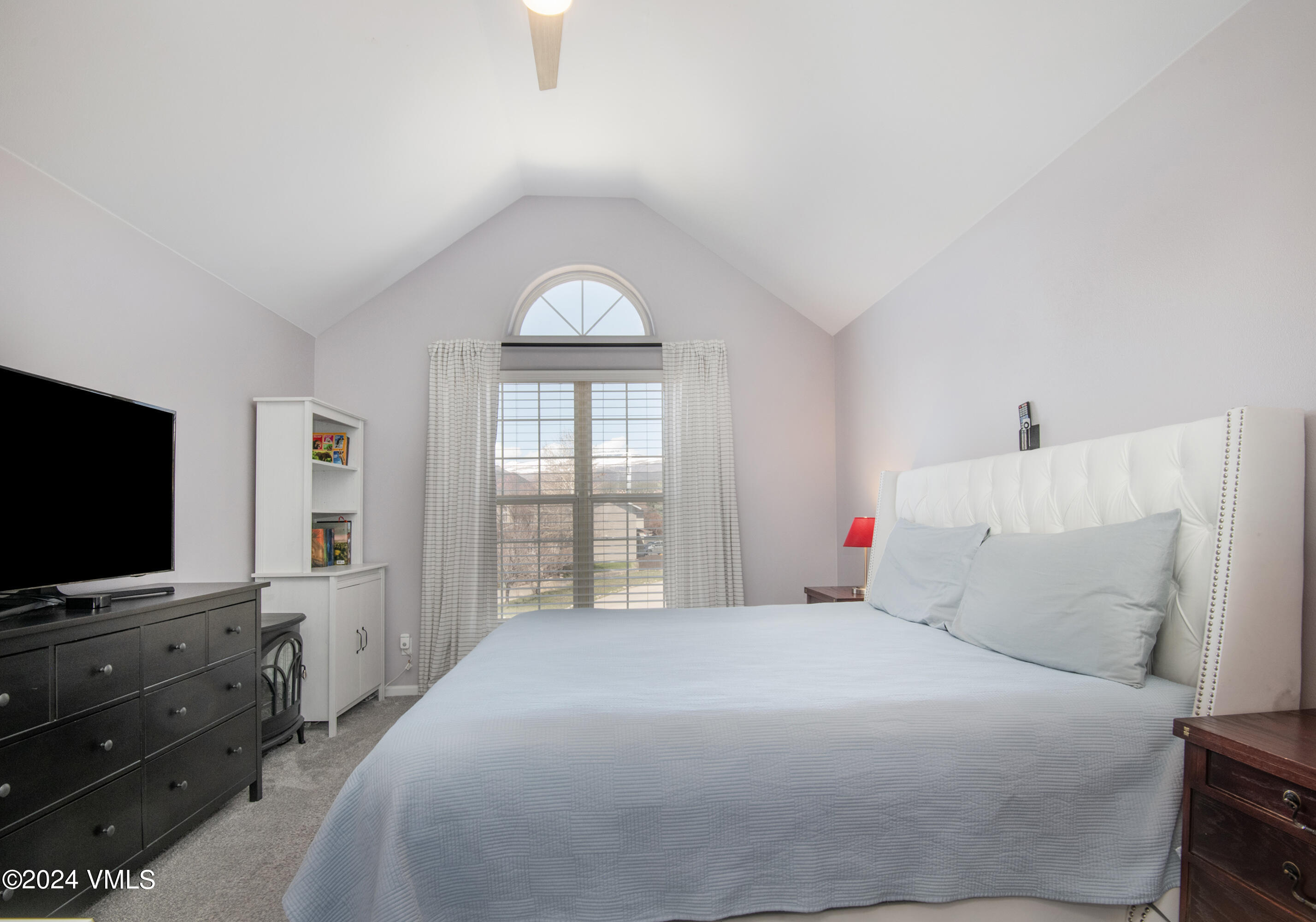 206 Golden Eagle Eagle, CO 81631 - Photo 25 of 47 a bedroom with a large bed and a flat screen tv