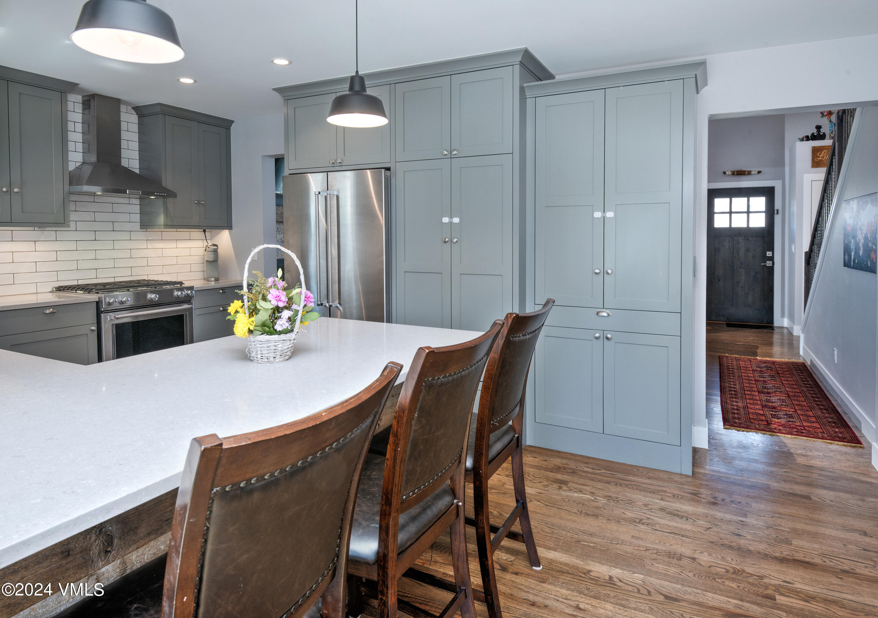 206 Golden Eagle Eagle, CO 81631 - Photo 7 of 47 a kitchen with stainless steel appliances a dining table chairs and refrigerator