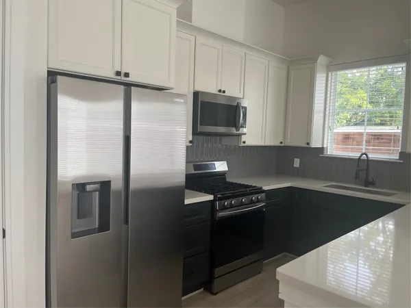 a kitchen with a refrigerator and a sink