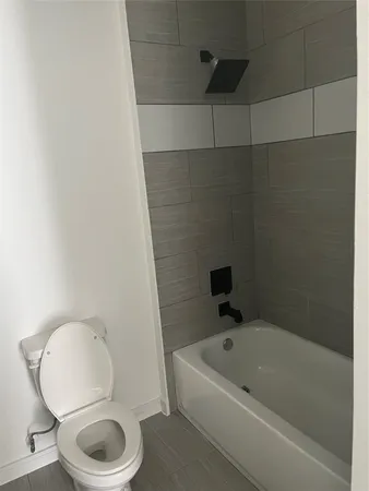a bathroom with a toilet and a bathtub