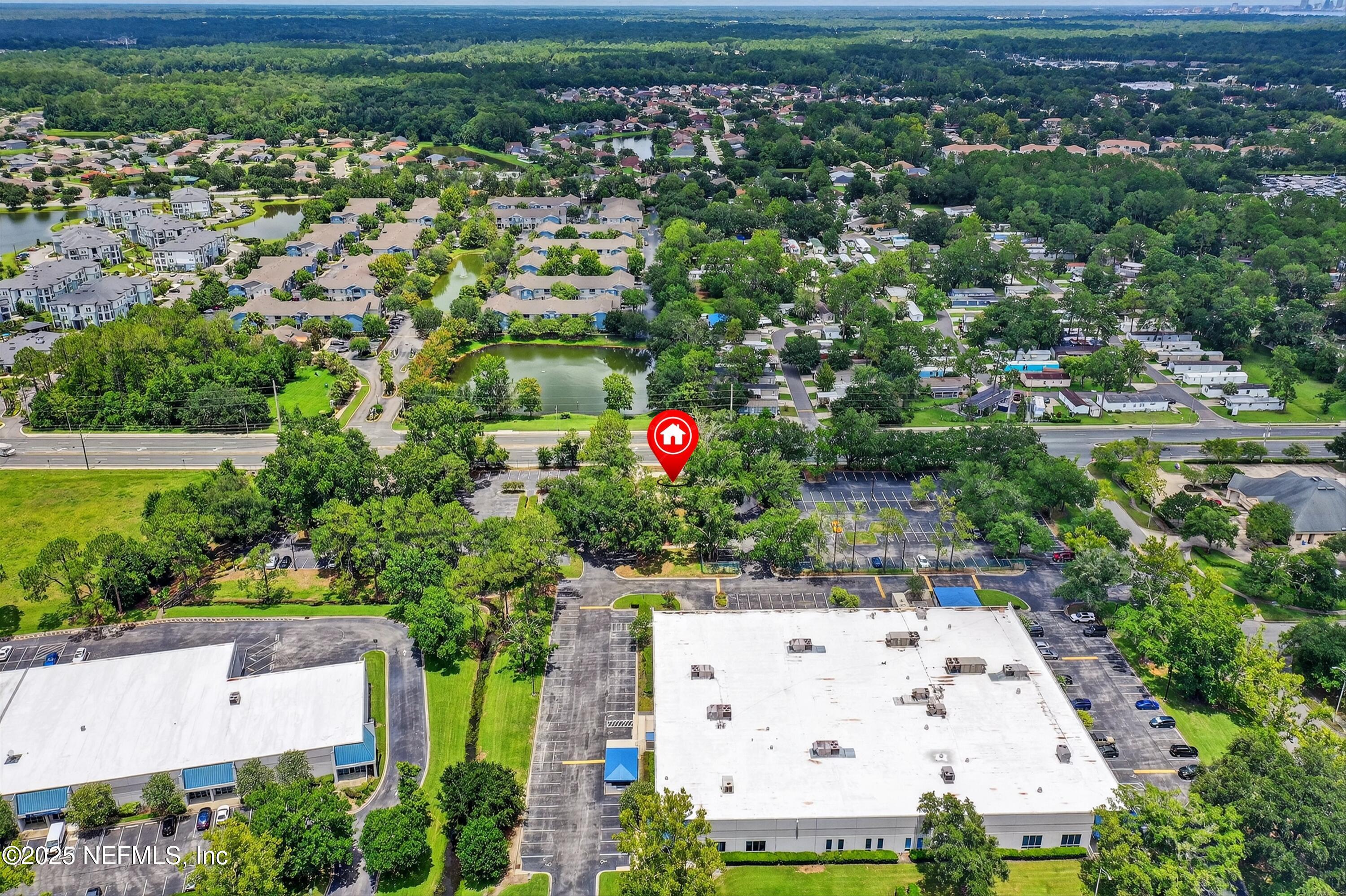 6346 Collins Road Jacksonville, FL 32244 - Photo 14 of 17 an aerial view of residential houses with outdoor space and trees