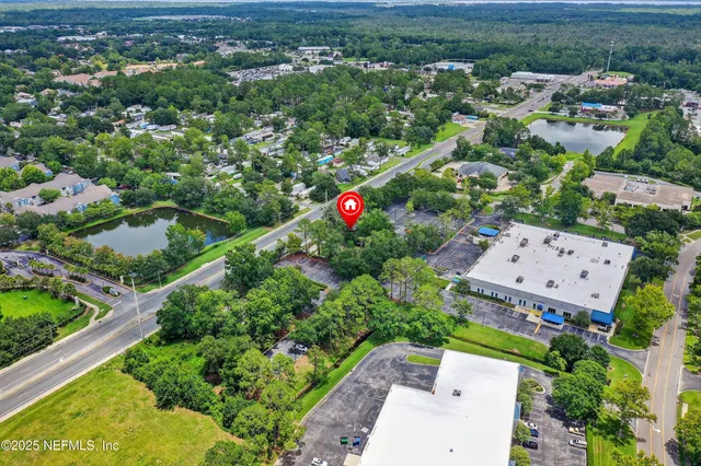 an aerial view of a house with a yard and lake view