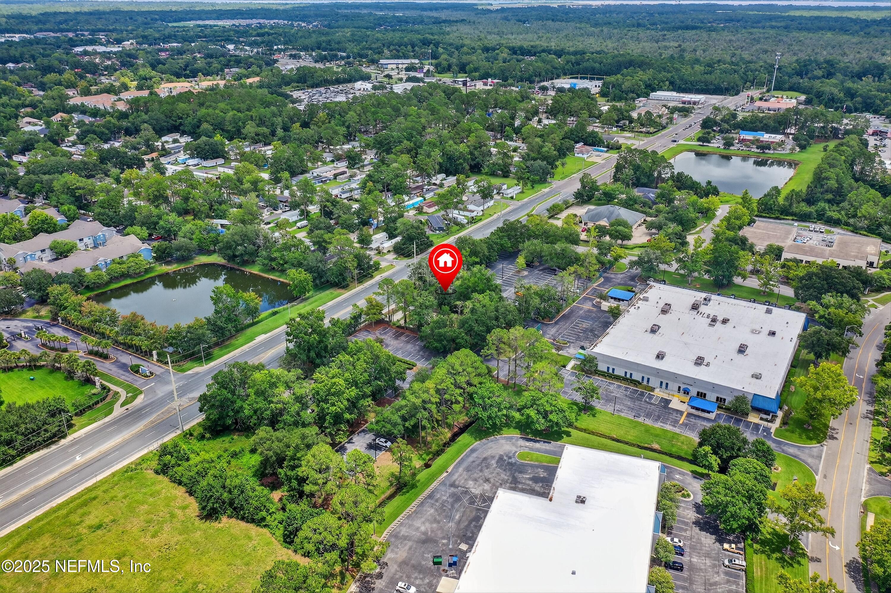 6346 Collins Road Jacksonville, FL 32244 - Photo 15 of 17 an aerial view of a house with a yard