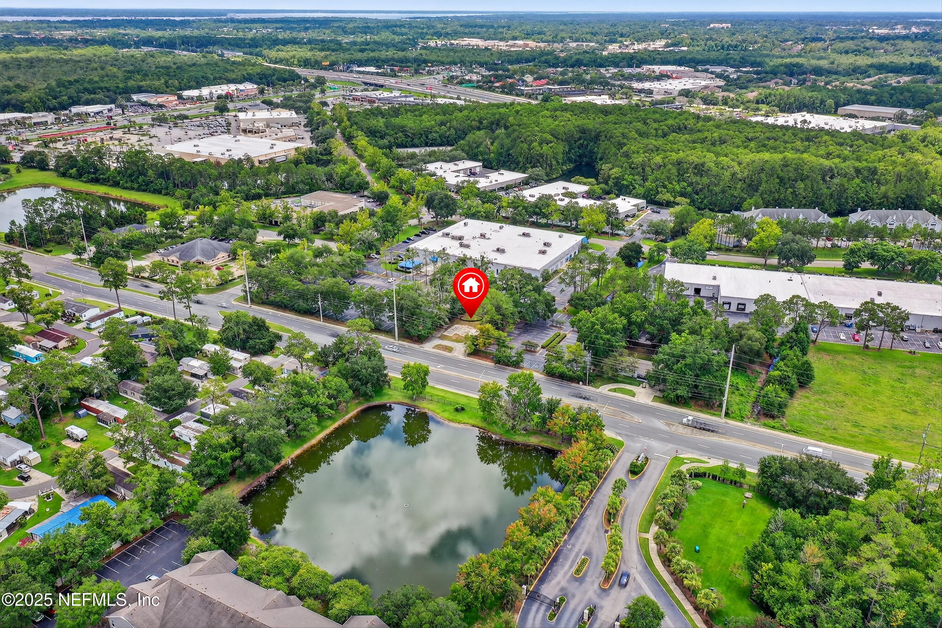 6346 Collins Road Jacksonville, FL 32244 - Photo 17 of 17 an aerial view of a house with a yard and lake view