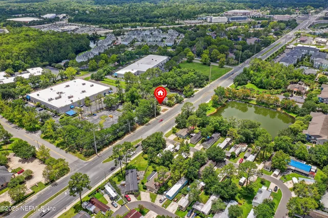 an aerial view of a house with a yard