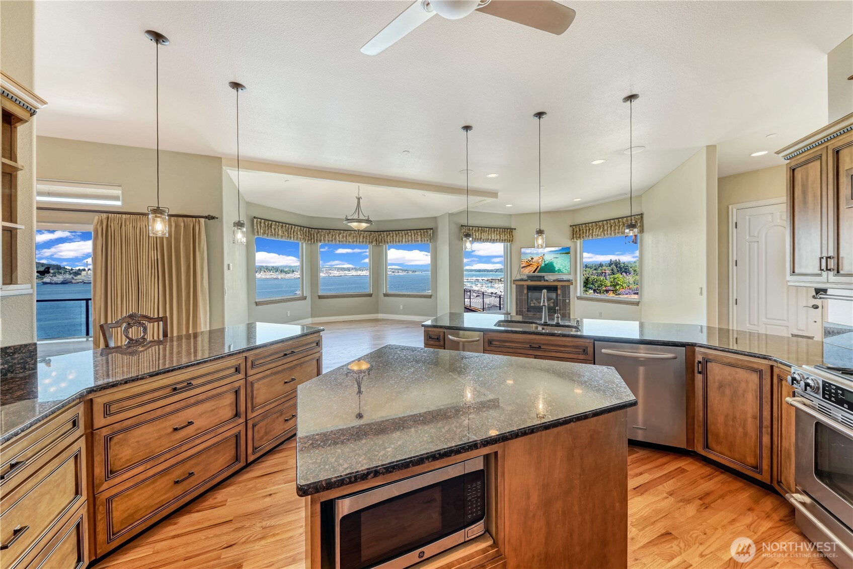 254 Caseco Lane Port Orchard, WA 98366 - Photo 15 of 28 a kitchen with stainless steel appliances granite countertop a sink a stove and a wooden floors