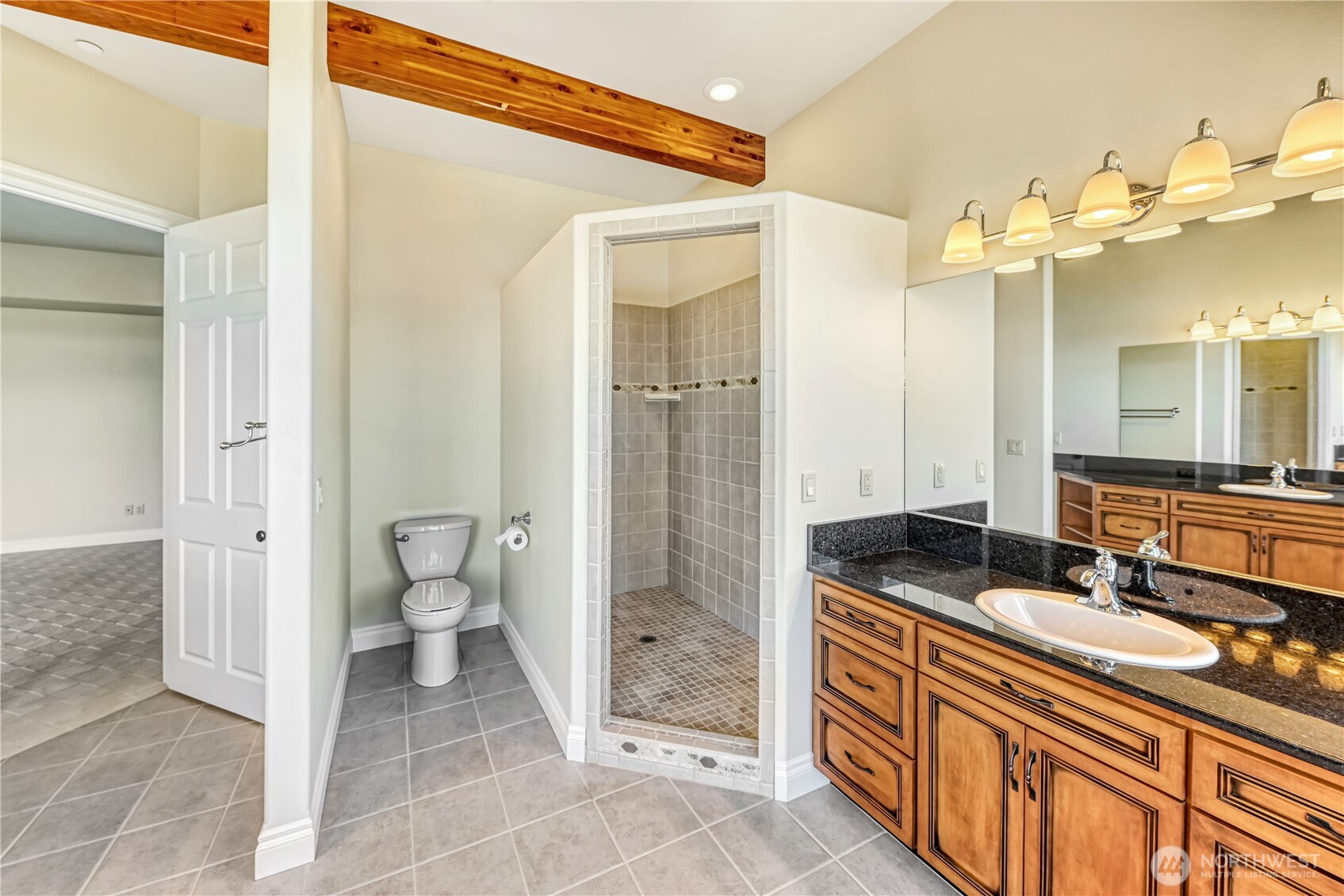 254 Caseco Lane Port Orchard, WA 98366 - Photo 23 of 28 a spacious bathroom with a granite countertop sink mirror and a shower