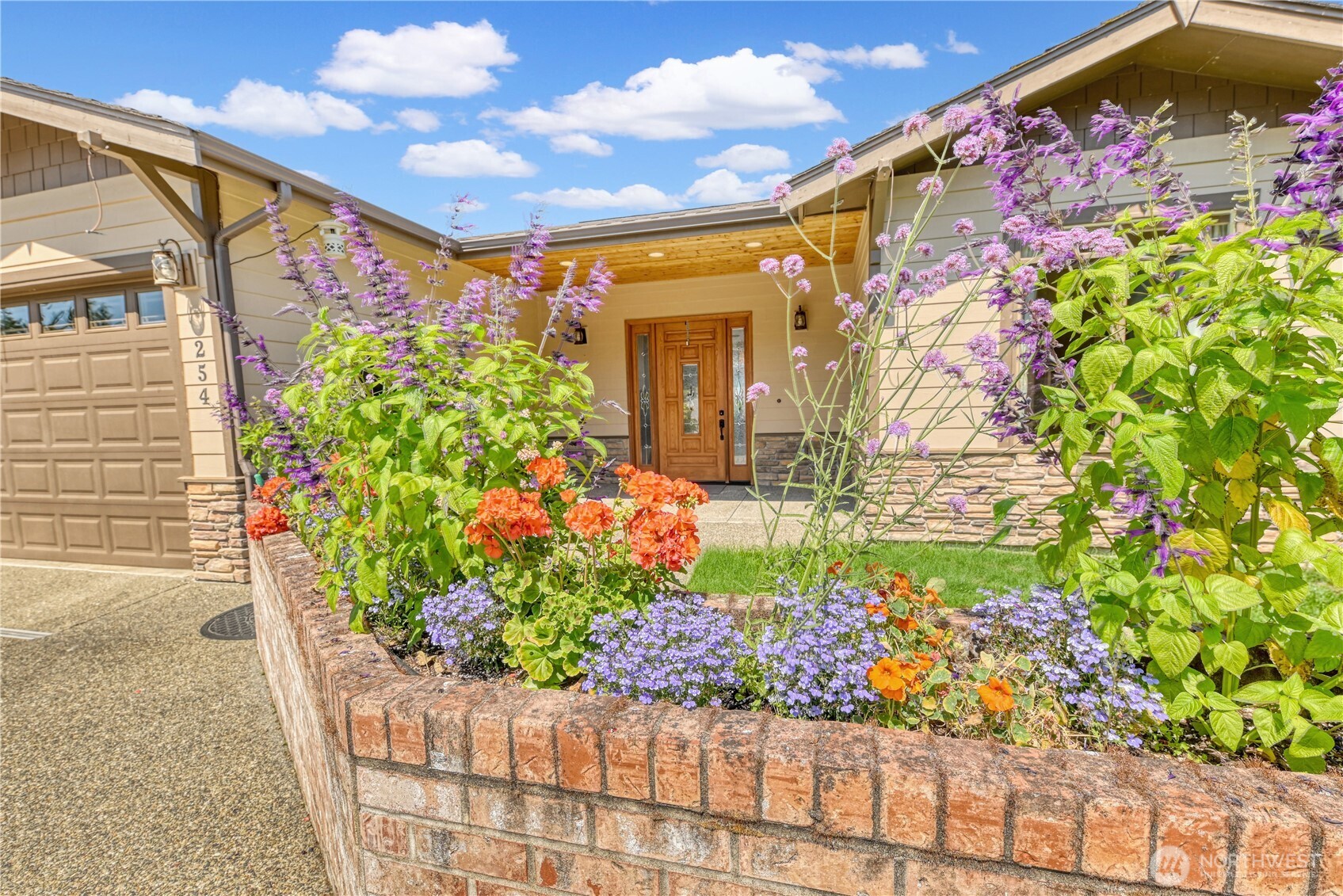 254 Caseco Lane Port Orchard, WA 98366 - Photo 5 of 28 a front view of a house with a lot of flowers