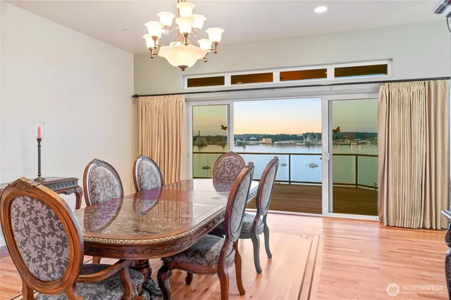 a view of a room with wooden floor and chandelier