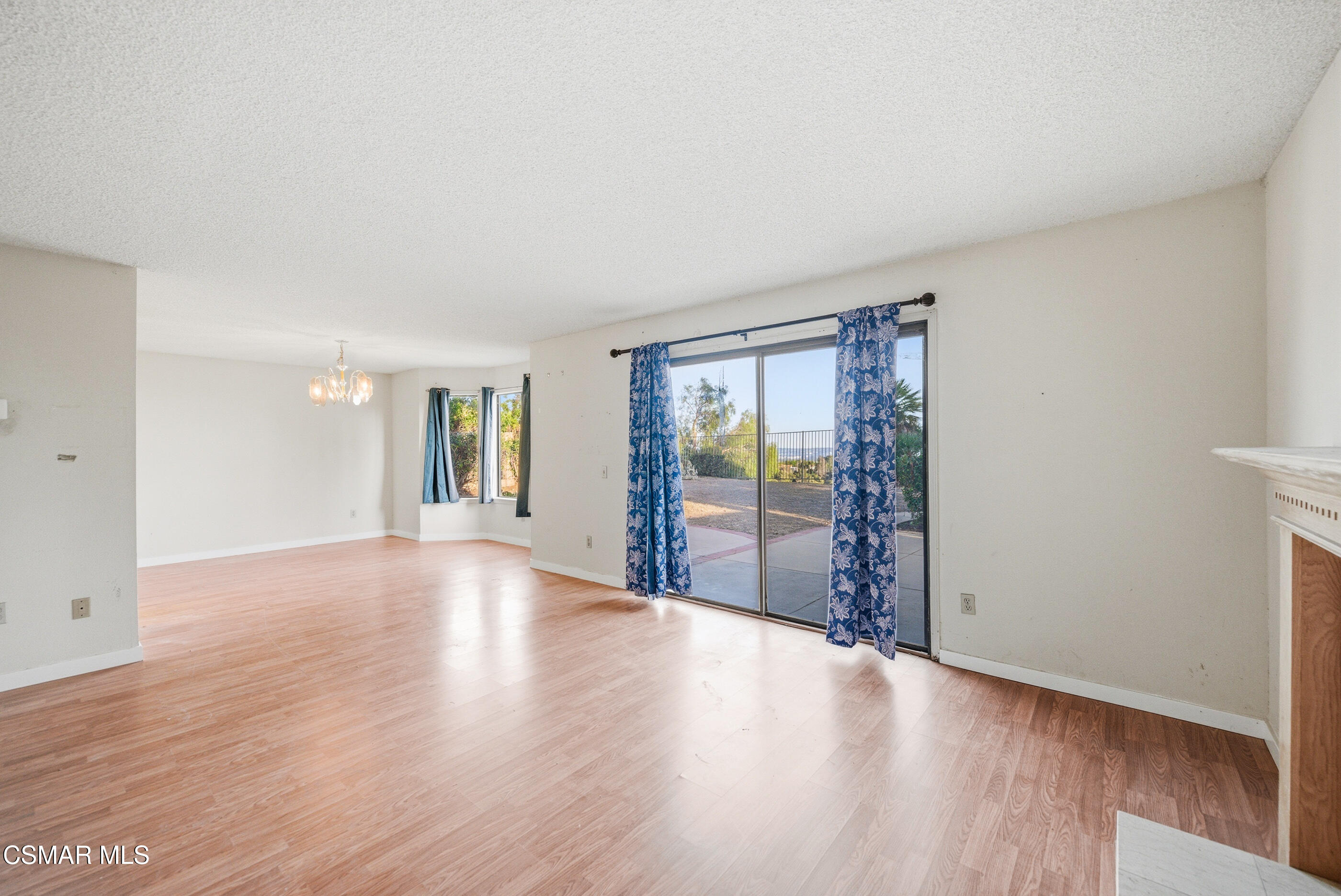 12036 Shadow Ridge Way Porter Ranch, CA 91326 - Photo 9 of 35 a view of an empty room with wooden floor and a window
