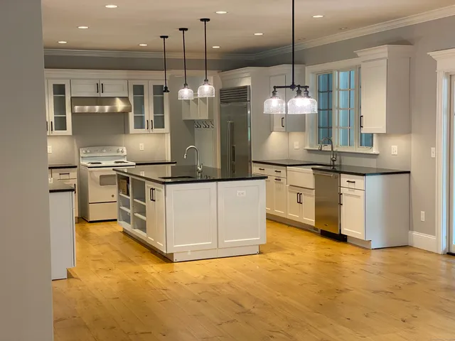 a kitchen with stainless steel appliances granite countertop a stove and a refrigerator