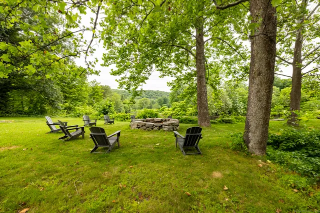 a backyard of a house with table and chairs