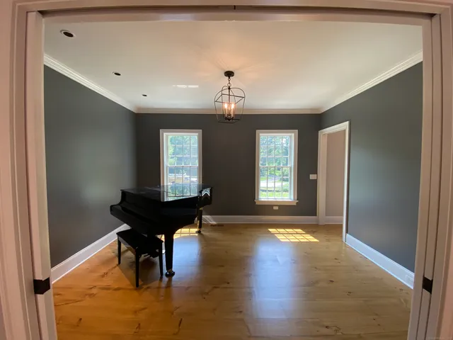 a view of a livingroom with furniture window and wooden floor