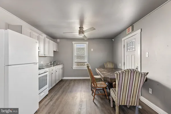 a kitchen with stainless steel appliances granite countertop a stove refrigerator and cabinets