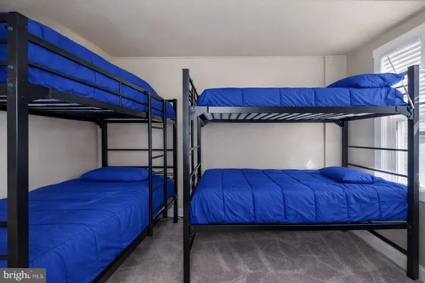 a view of a bedroom with furniture and windows