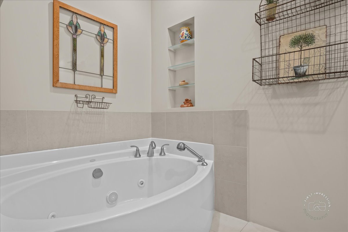 705 Meadows Road Geneva, IL 60134 - Photo 16 of 27 a bathroom with a bathtub and shower